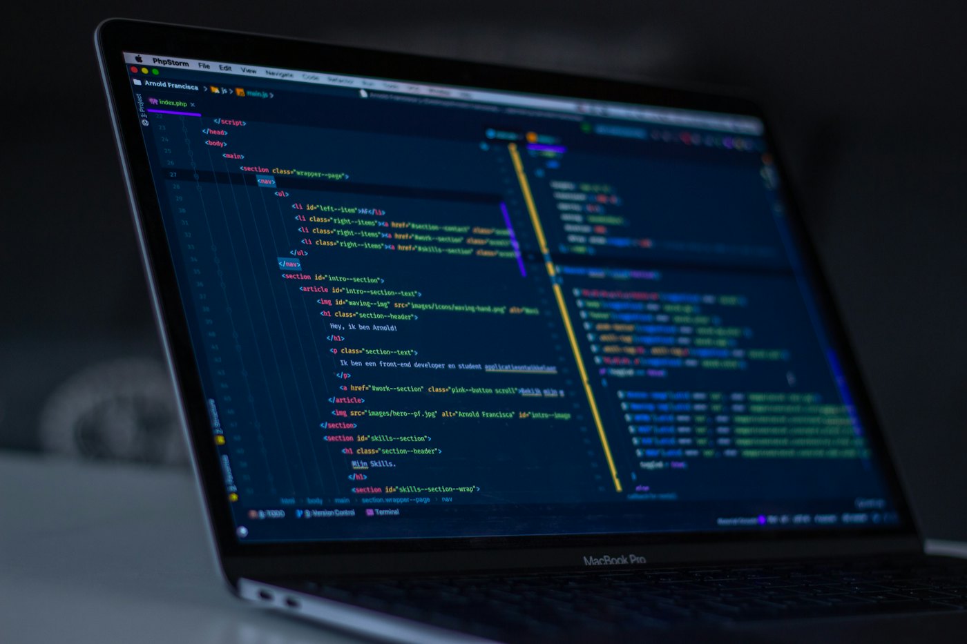Colorful programming code syntax highlighting on a dark screen